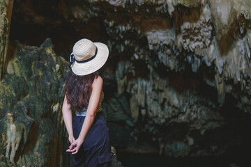 Back view of a young Asian woman enjoying holiday and scenery at Rangko Cave, Labuan Bajo.