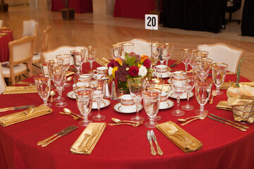 Table Setting Red Tablecloth Gold Cutlery Floral Centerpiece Special Occasion
