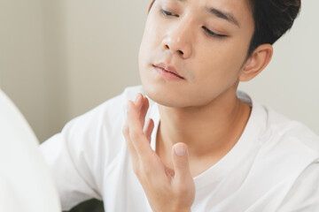 Asian men worry about acne on their faces when looking in the mirror