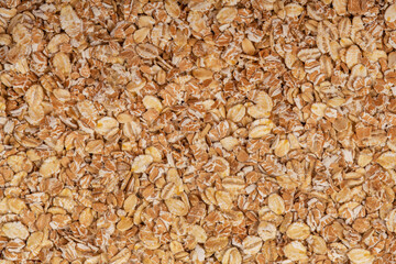 Macro shot of oat flakes showing their natural texture and color, great for backgrounds or nutrition-related concepts.
