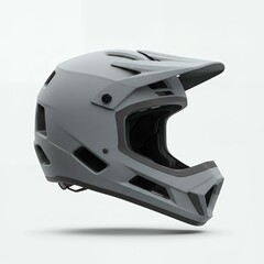 Fototapeta premium Side profile view of matte gray full-face mountain bike helmet with extended visor and ventilation ports for downhill racing protection