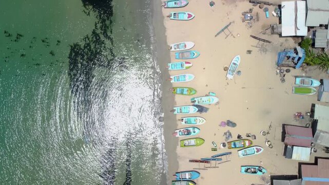 Top-Down Aerial Tracking Shot of Fishing Boats Lined on Beach in Trincomalee Sri Lanka