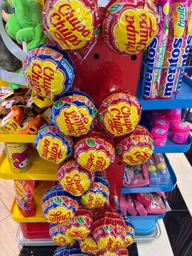 Thessaloniki, Greece - august 09, 2025: a variety of colorful chupa chups and mentos candies on a retail display stand, concept of sweets, confectionery, and children's treats.