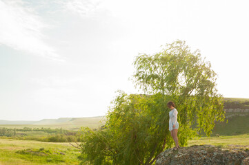 Obraz premium Photo session outdoors of a pretty girl in shorts, a shirt and a dress