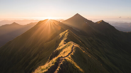 Majestic mountain landscape with rugged peaks against a clear blue sky and vibrant green foreground