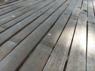 Rustic Wooden Deck Planks with Natural Sunlight and Weathered Texture