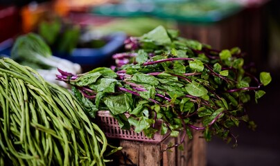 Green vegetables displayed at a market stall