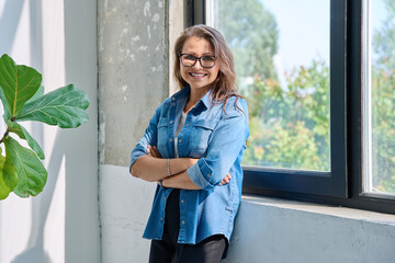 Portrait confident middle aged woman posing with crossed arms