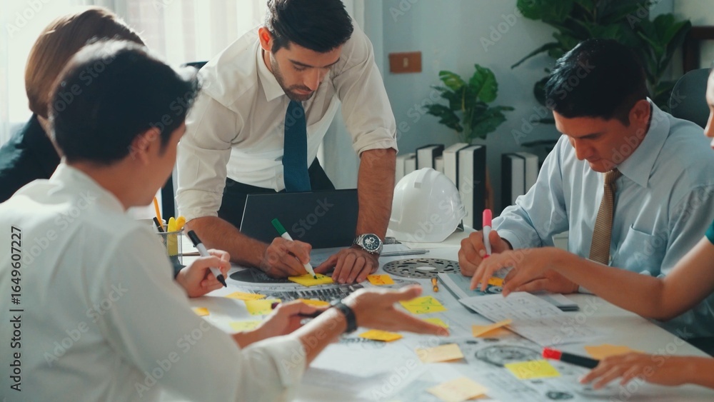 Poster group of diverse team planning strategy while sitting at table with project plan. top aerial view of