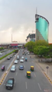 Blurry view of the vehicle traffic on the road near Cybercity metro station in Gurgaon, India. Bokeh time lapse motion video for background.