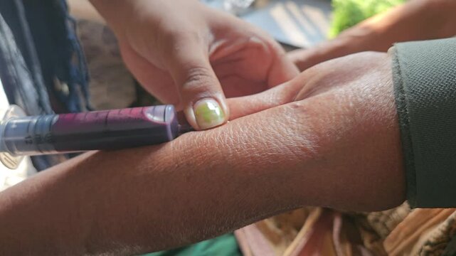 Nurse collecting blood from patient in hospital, Diagnosis and Healthcare Concept. Odisha, India
