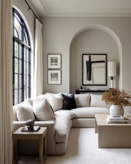 Neutral-toned living room with an archway and sectional sofa.