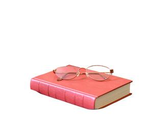 A mustard-yellow water bottle, a teal-colored book, and gold-rimmed eyeglasses on a b