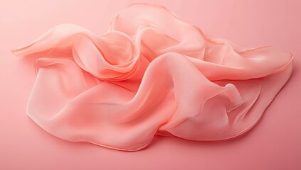 Delicate, pale pink silk or chiffon fabric draped in soft curves on a matching background