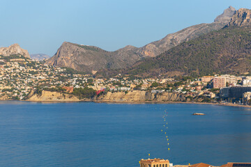 Morning Calm in Calpe, A serene view of Calpe Bay at sunrise, where a yellow buoy on the calm blue...