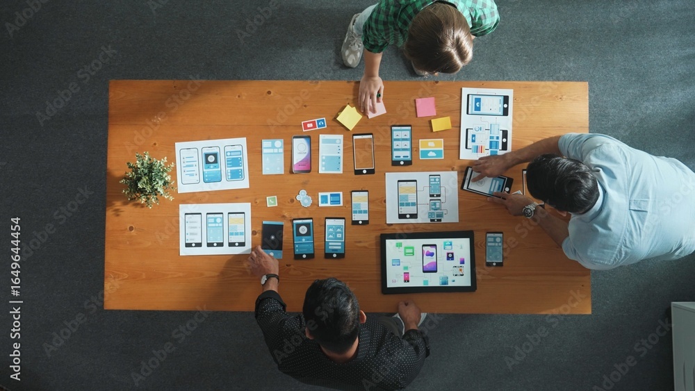Poster manager taking a note in sticky note while software developer team working on ux ui design for mobil