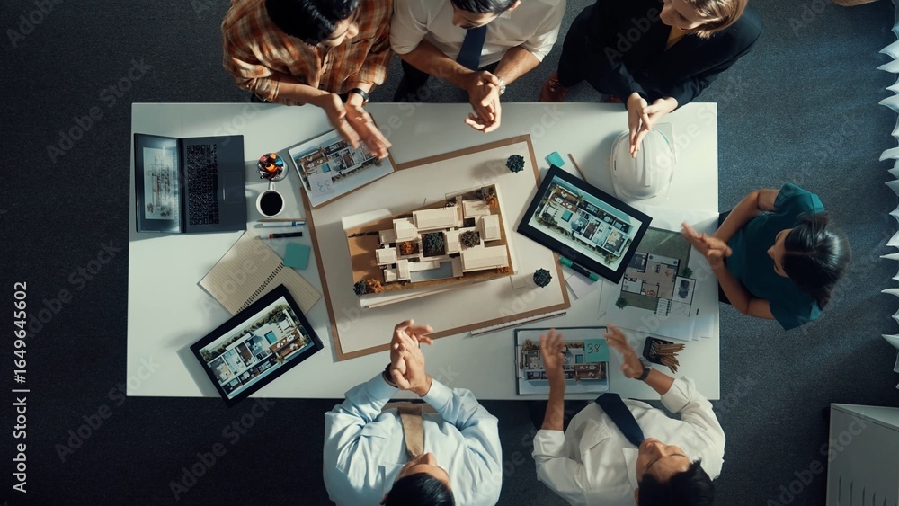 Poster time lapse of manager pointing at house model and explain building design. aerial view of architect 