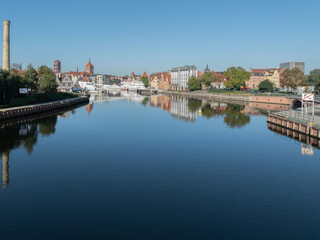 Panoramic view of Gdańsk Old Town waterfront with reflections on the Motława River, Poland