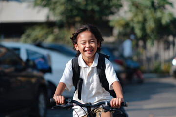 Happy student riding bicycle to school