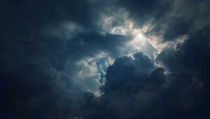 Obraz premium Dramatic sunlight breaking through dark storm clouds