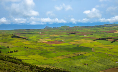 Panoramic view of the colorful agricultural fields from Serra do Cume lookout on Terceira Island,...