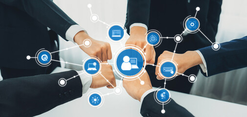 A diverse business team engages in collaboration, showcasing unity and support as digital...
