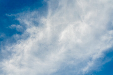 A close-up shot of a clear blue sky with long, wispy white clouds creating a sense of movement and drama. The photo was taken over the serene Nile River near Luxor and Esna.