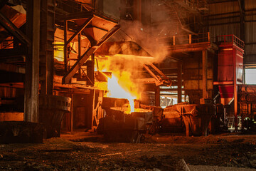 Liquid metal pours from a ladle