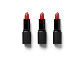 Obraz premium Three matte black lipsticks aligned perfectly against pure white minimalist backdrop