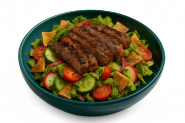 Grilled lamb fattoush salad with crisp vegetables, herb-seasoned pita chips, served in green ceramic bowl against clean white backdrop