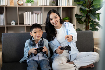 Gaming Together. Mother and son enjoying video games on the couch.