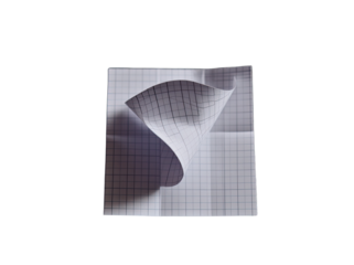 A square sheet of grid paper, creased and folded into a conical shape, centered on a black background