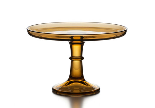 Isolated amber glass cake stand with pedestal base on a white background showing the reflection