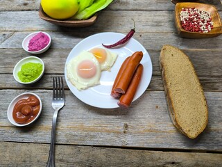 delicious mouth-watering breakfast of fried eggs and sausages on a plate