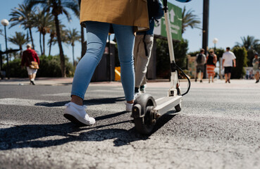 Obraz premium Woman with e scooter in town, transportation concept
