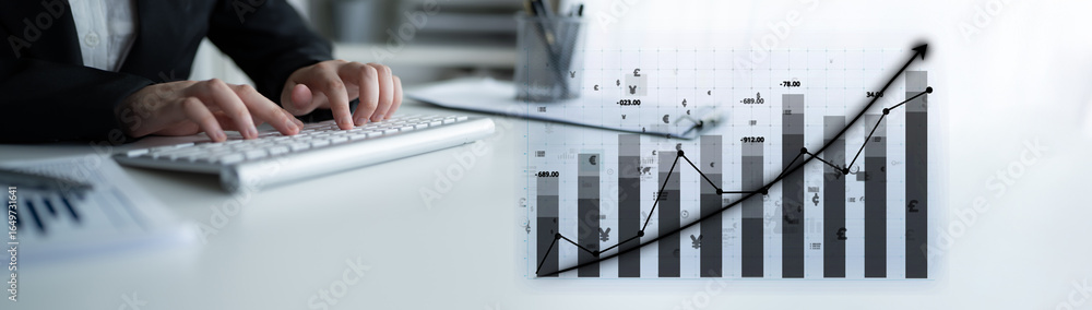 Poster a business professional engages in financial data analysis while typing on a laptop. graphs and char