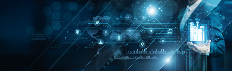 Businessman holding building of smart cities infrastructure, IoT connectivity data automation...