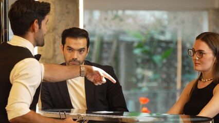 Smiling smart VIP customer inviting friend or couple for sitting at beverage counter bar talking with bartender while preparing welcome drink professionalism making great first impression. Vinosity.