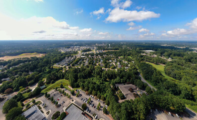 Fototapeta premium Sunny Daytime Drone Images of Wake Forest, North Carolina Featuring the Downtown Historic District, Businesses, and Residential Developments: Tourism, Real Estate, Travel