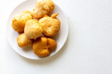 Golden Fried Dough Pieces on a White Plate: Classic American Treat Perfect for Any Occasion