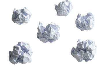 Several crumpled white office papers, some balled, some textured, centrally placed on a clean light desk, high-angle studio shot, symbolic of business challenges