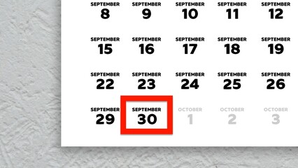 Close-up of the date September 30th marked with a red cursor on the wall calendar 2025