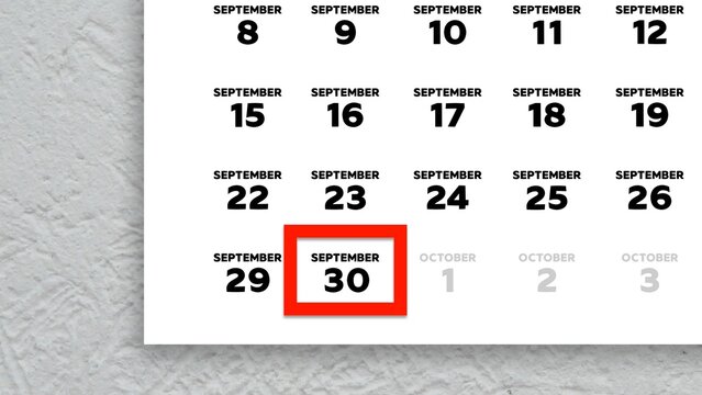 Close-up of the date September 30th marked with a red cursor on the wall calendar 2025