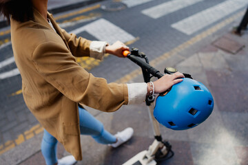 Woman with e scooter in town, transportation concept