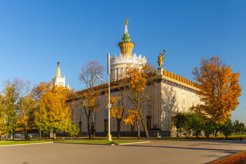 Beautiful Pavilion at VDNH Exhibition Center surrounded by autumn trees with golden foliage under a...