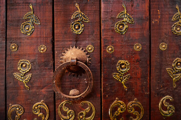 Vintage ancient door ring for knocking on red oriental antique door