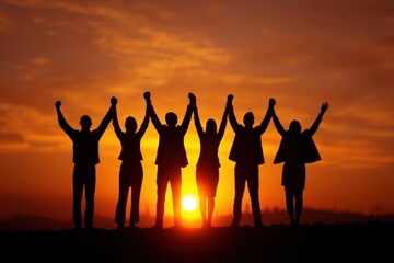 Fototapeta premium Celebratory Silhouette of a Thriving Business Team in a Sunset Sky - The Essence of Partnership and Teamwork