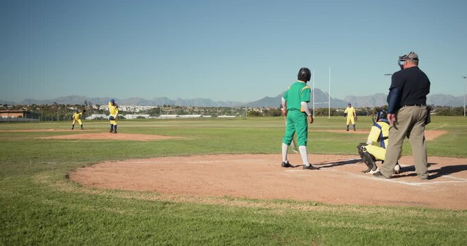 Pitcher winding up delivering inside fastball, batter leaning back, shuffling to avoid hit by pitch