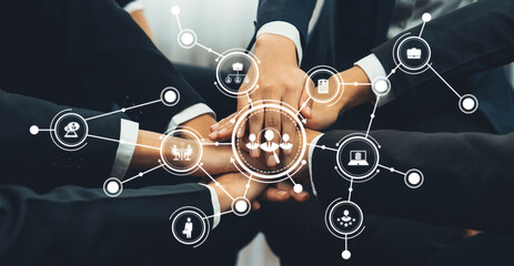 A close-up view of diverse business professionals' hands working collaboratively, highlighted by...