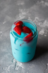 Blue milk cocktail with strawberries. Selective focus.